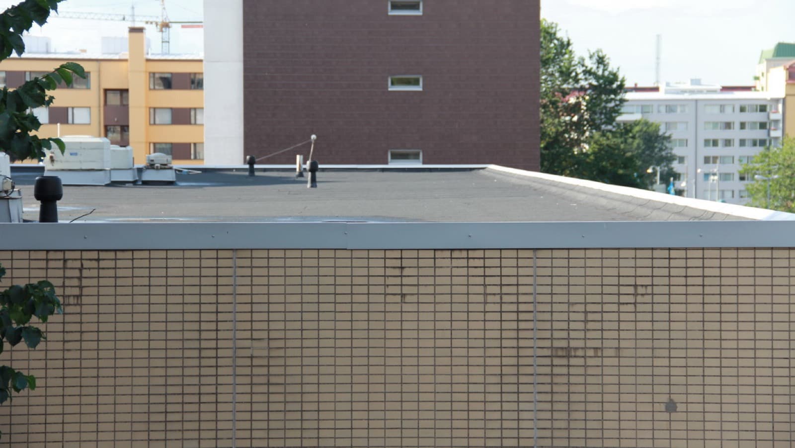Flat commercial roof with rooftop HVAC units on a South Florida building